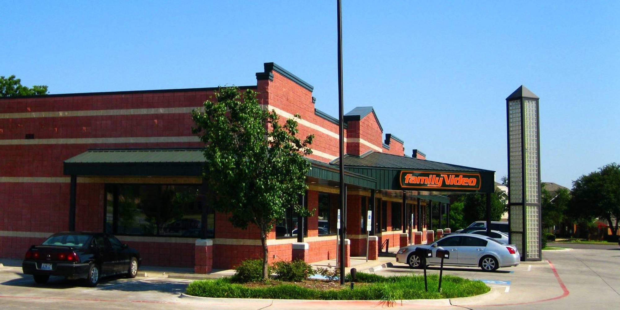 Later Family Video prototype with a stepped brick facade, green roof and glass-block tower