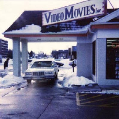 Early Video Movies Inc. storefront with a covered driveway in winter