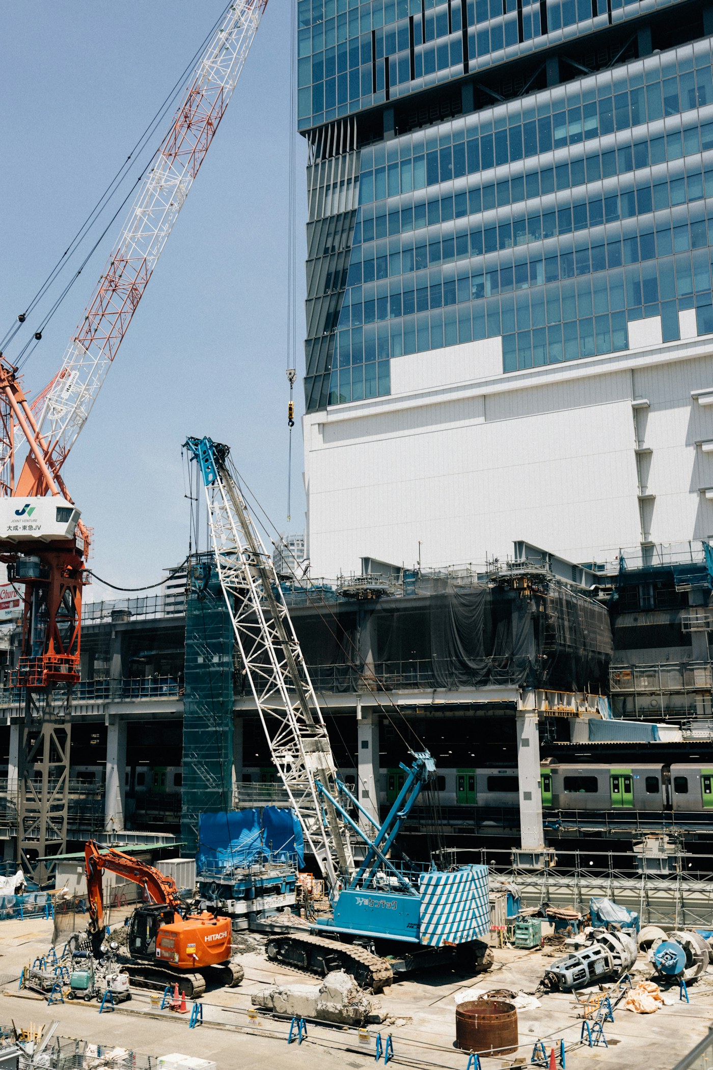 Active commercial construction site with cranes